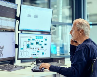 Control room with men at PC